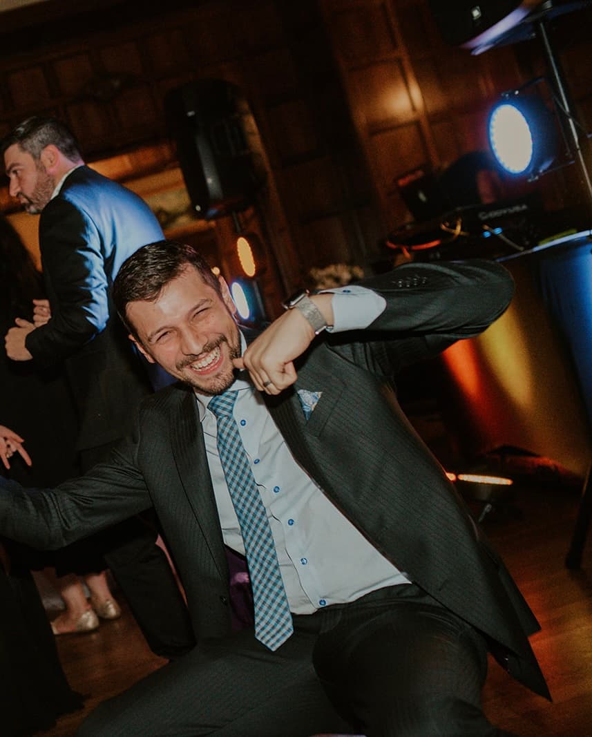 Anthony Ramirez smiling and dancing in a vest.